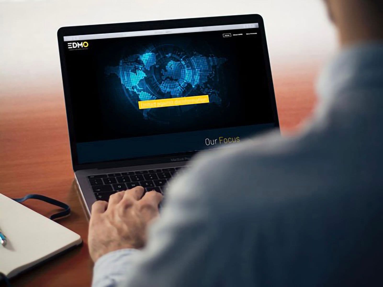 Picture shows a person visiting the EDMO website on a laptop.