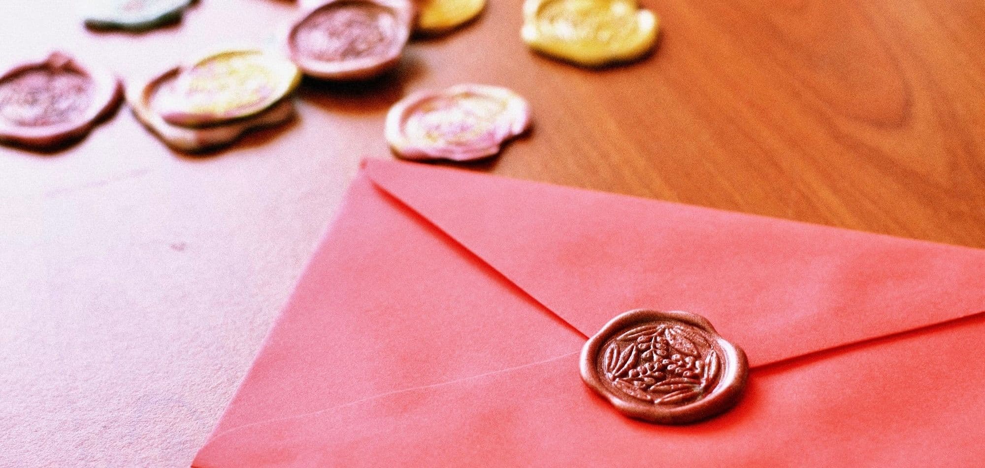 A photo of a sealed paper envelop with more seals in the background. Credits: Natasya Chen on Unsplash
