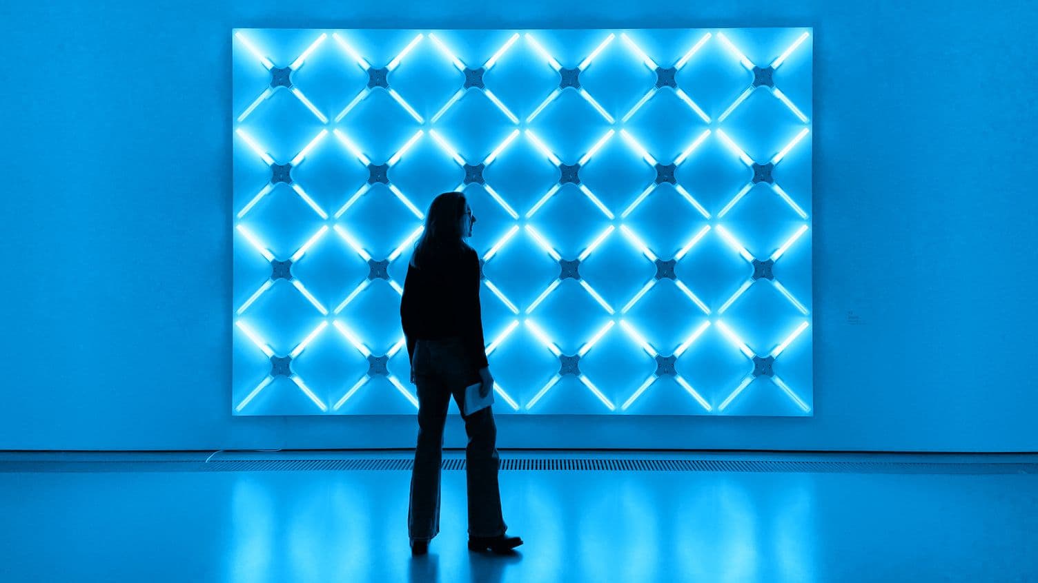 A woman in front of a light wall in a museum. Photo taken by Olivia Stracke.